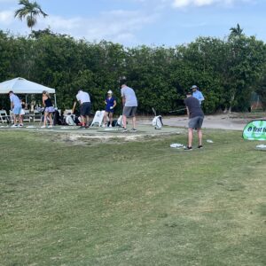 People playing lawn bowling outdoors on a sunny day.